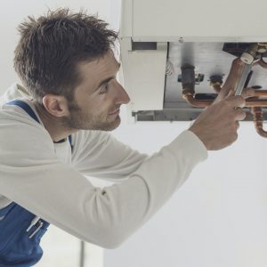 Professional plumber checking a boiler